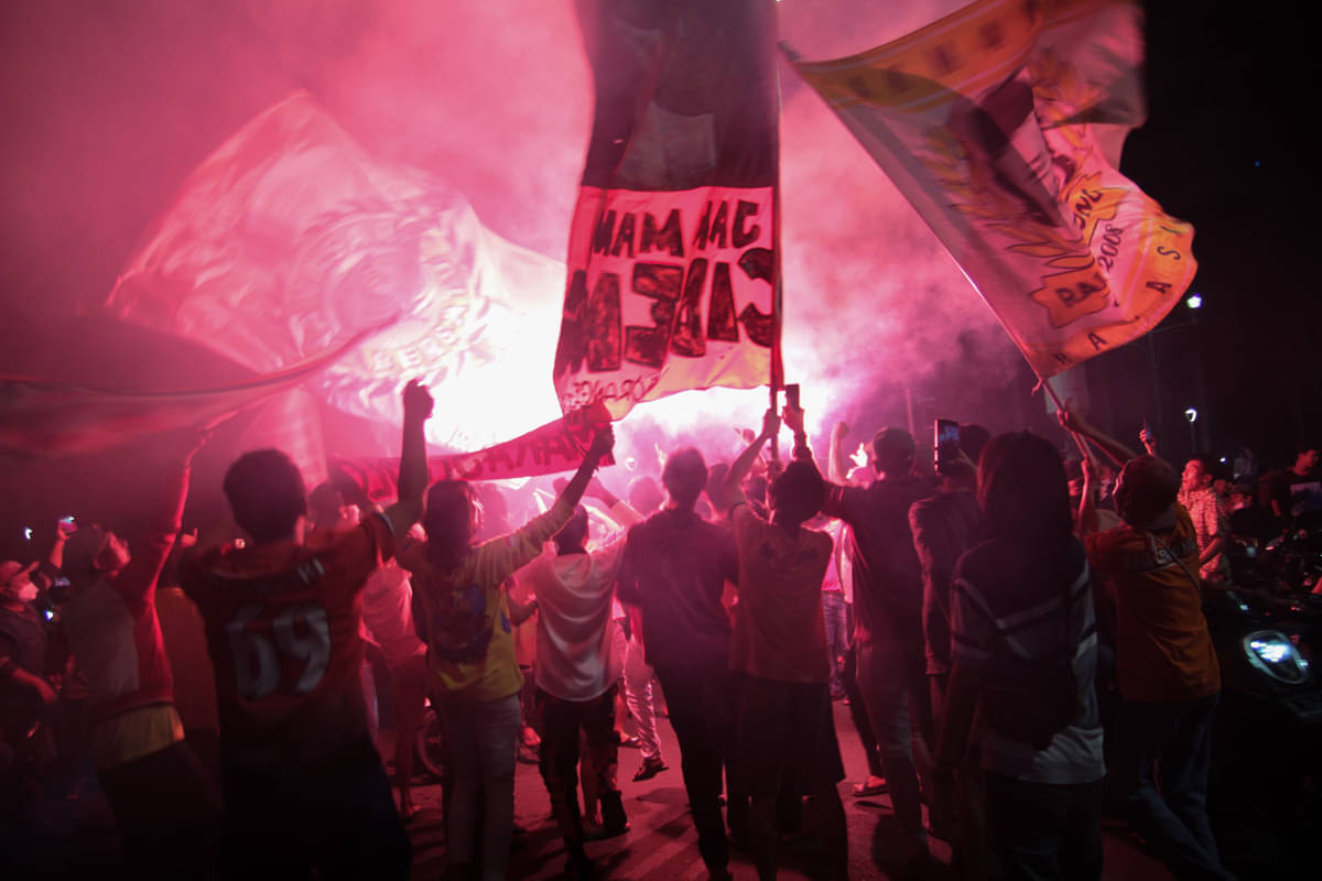 Suporter Persija menyalakan flare saat merayakan kemenangan Persija Jakarta pada laga final Piala Menpora 2021.