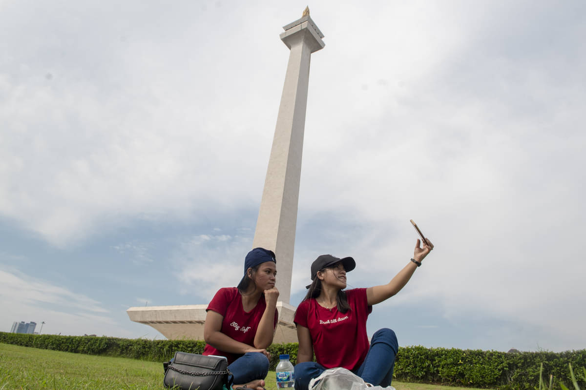 Warga berswafoto di kawasan Monumen Nasional, Jakarta.