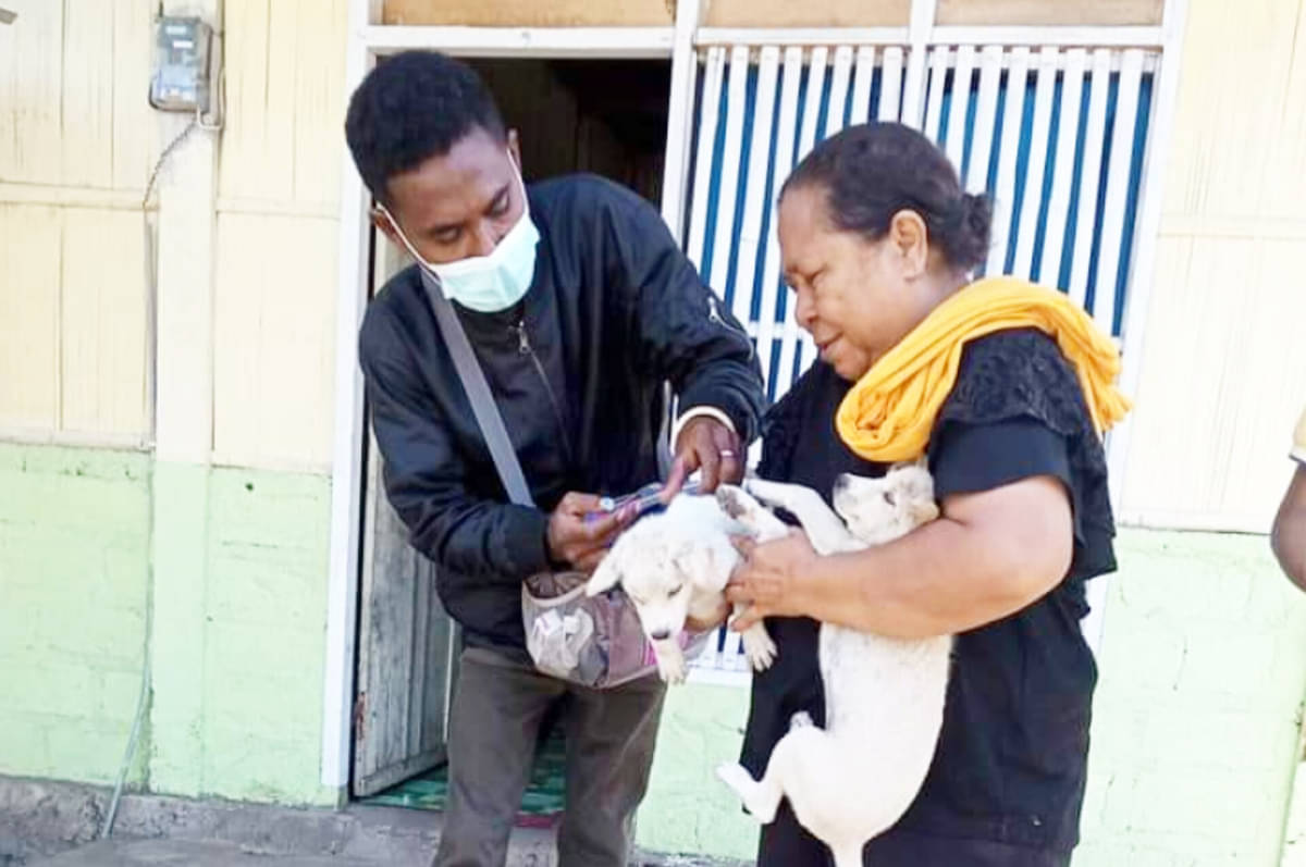 Warga memberikan vaksin rabies kepada hewan peliharaannya