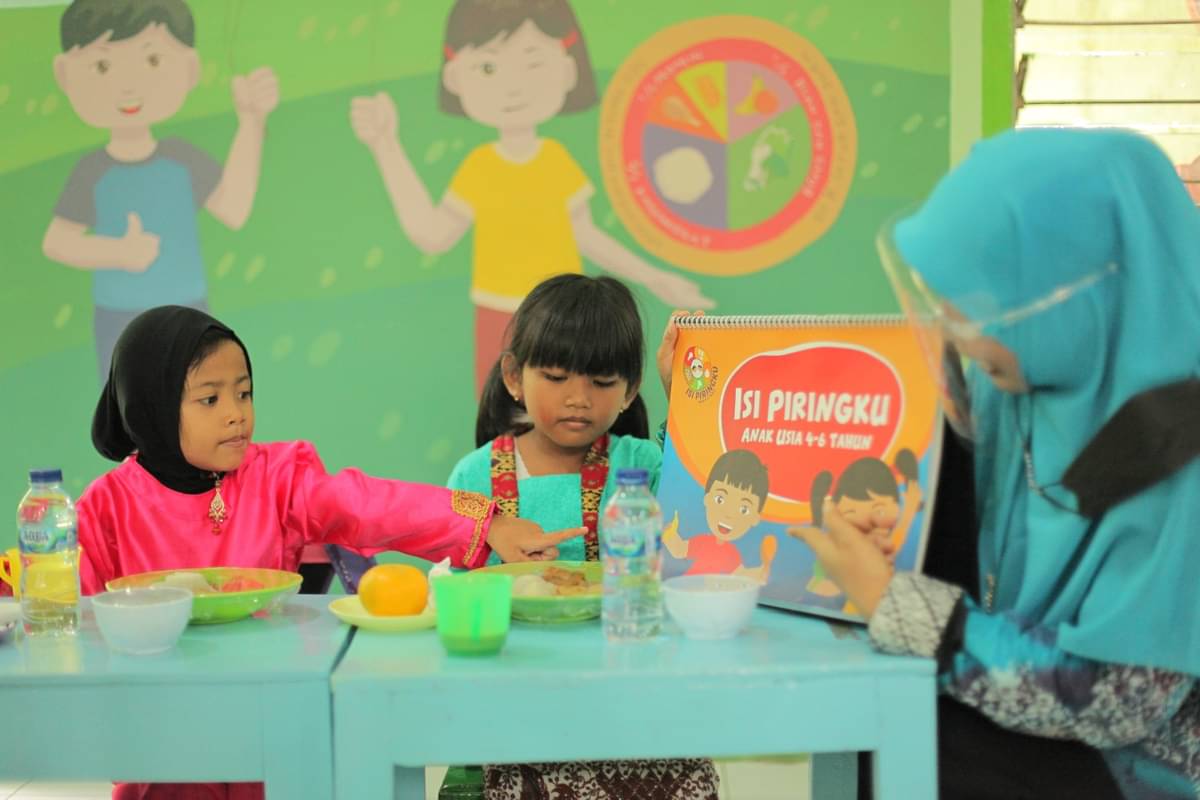 Anak-anak menyimak penjelasan konsep Isi Piringku sebagai panduan konsumsi makanan bergizi seimbang. 